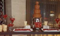 Strawberries dipped in warm chocolate flowing in the fountain.  Dreams are made of this.