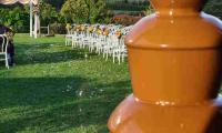 A chocolate fountain inside looking out at the picturesque setting for the wedding.